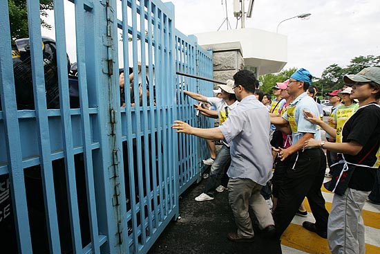 '철문 사이로도 날아오는 곤봉'. [사진-통일뉴스 김주영 기자]