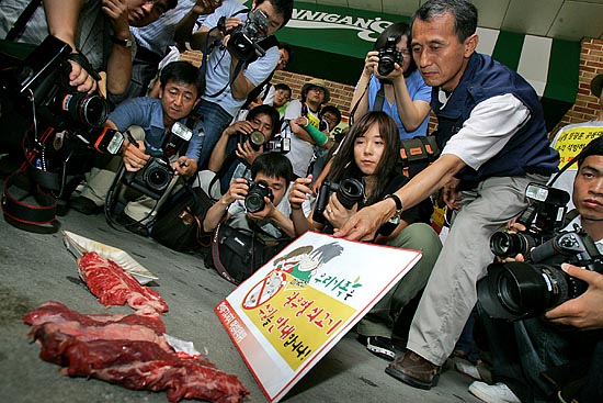 '한미FTA저지범국본'소속 회원들과 '광우병위험 미국산 쇠고기 국민감시단'이 13일 오전 10시 미국산 쇠고기 첫 시판에 나선 서울 봉래동 롯데마트 서울역점 앞에서 미국산 쇠고기를  바닥에 던져놓은 채 광우병 쇠고기 시판을 규탄하고 있다.  [사진-통일뉴스 김주영 기자]