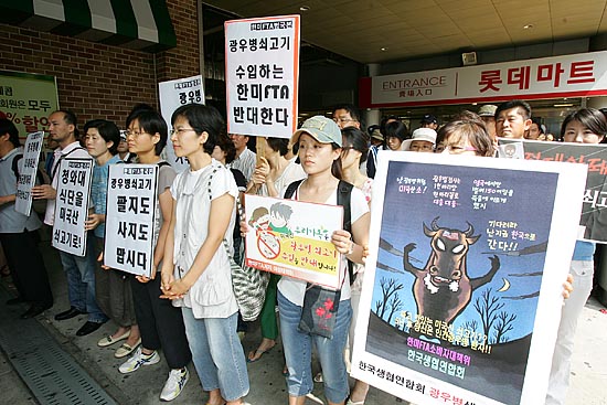 롯데마트는 이날 오전 10시부터 전국 53개 매장에서 미국산 쇠고기 시식과 시판에 나섰다. 사진은 롯데마트 서울역점 출입구 앞에서 광우병 국민감시단과 '한미FTA저지범국본'의 규탄집회 모습. [사진-통일뉴스 김주영 기자]