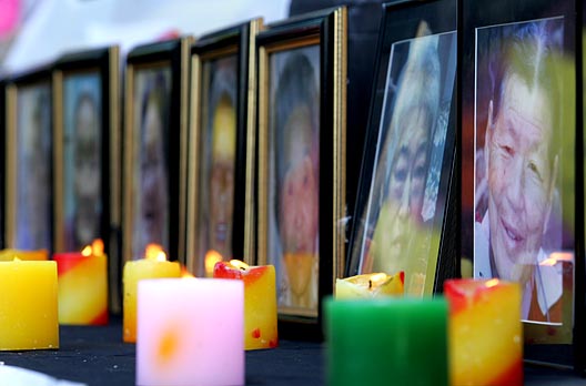 일본 정부의 공식사죄를 받지 못하고 눈을 감은 13명'위안부'피해자 할머니들의 영정사진이 올려진 추모단상에 촛불이 밝혀졌다. [사진-통일뉴스 김주영 기자]