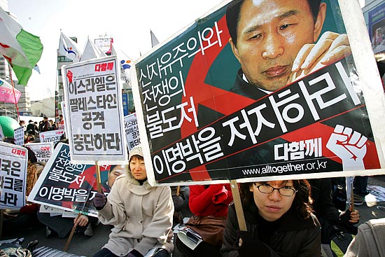 26일 오후 서울역 앞 광장에서 다보스 세계경제포럼(WEF)을 반대하는'세계사회포럼(WSF)' 한국 조직위원회 주최로 '세계행동의 날' 집회가 열렸다. 이명박 당선자의 개발주의 정책을 비판하는 피켓을 든 참가자.  [사진-통일뉴스 김주영 기자]