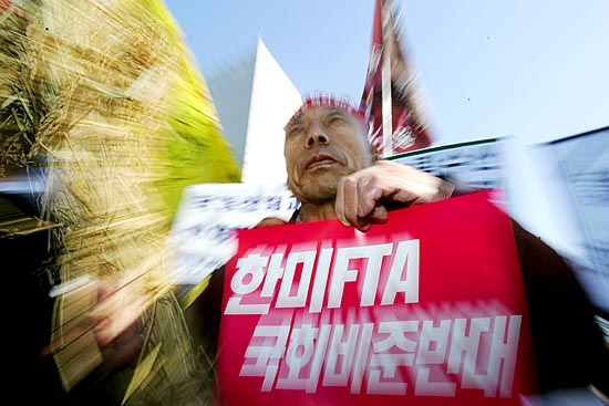 국회 통일외교통상위원회의 '한.미FTA' 비준 동의안 상정을 반대하며 14일 오후 서울 여의도에서 열린‘한.미FTA저지,농민생존권쟁취 전국농민결의대회'에서 한 농민이 볏단을 들고 나왔다.[사진-통일뉴스 김주영 기자]