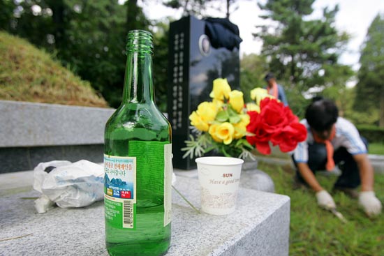 평생 전기노동자로 살다가 노동탄압에 맞서 분신항거한 정해진 열사의 묘 주위를 정돈 하고 있는 조합원.[사진-통일뉴스 조성봉 기자]