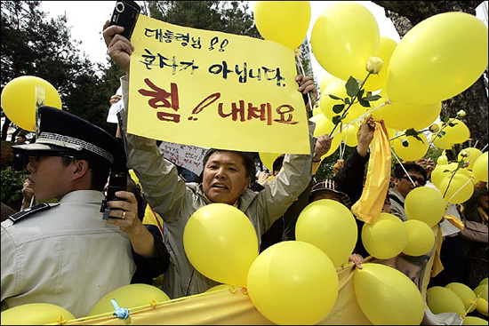 노란풍선과 격려 구호가 적힌 피켓을 든 노무현 전 대통령 지지자들이 버스행렬을 향해 환호를 하고 있다.[사진-인터넷사진공동취재단]