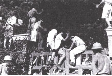 조선정판사 ‘위조지폐’ 사건의 비공개 재판을 반대하는 민청원들이 재판소 문을 넘으려 하고 있다. 1950년 10월 26일 미군이 평양에서 획득한 사진이다.