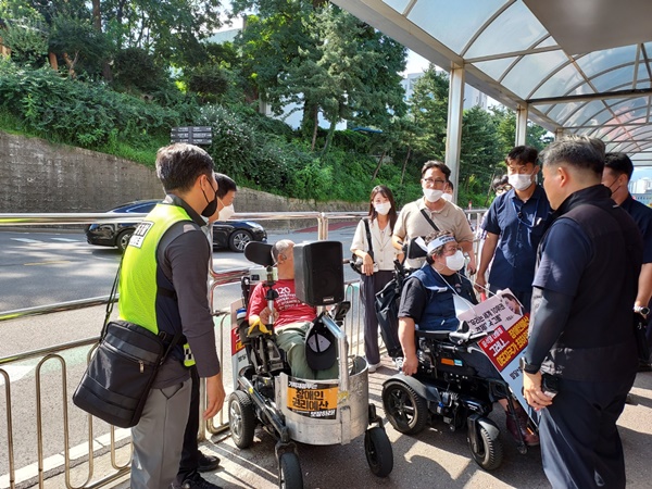 16일 오전 한 장애인 단체가 대통령실 진입문(구 국방부 서문) 입구에서 경내로 들어가려다 경비에 막혔다. [사진-통일뉴스 이광길 기자]
