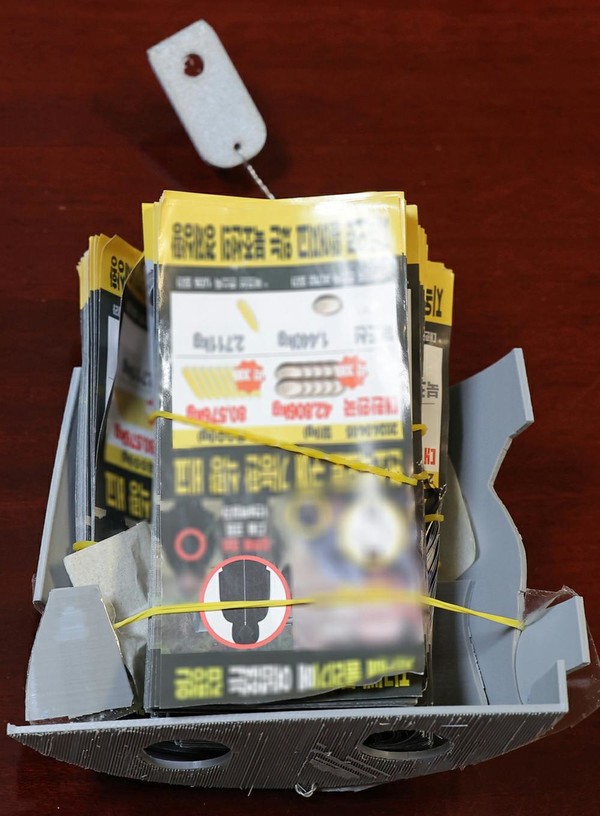 북한이 공개한, 적 무인기에서 살포된 전단들과 전단묶음통. [사진-노동신문 갈무리]